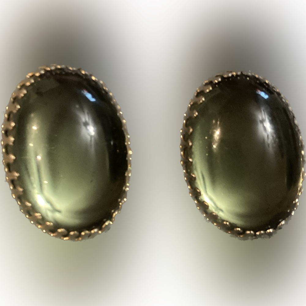 Vintage green oval clip on earrings in a gold toned setting